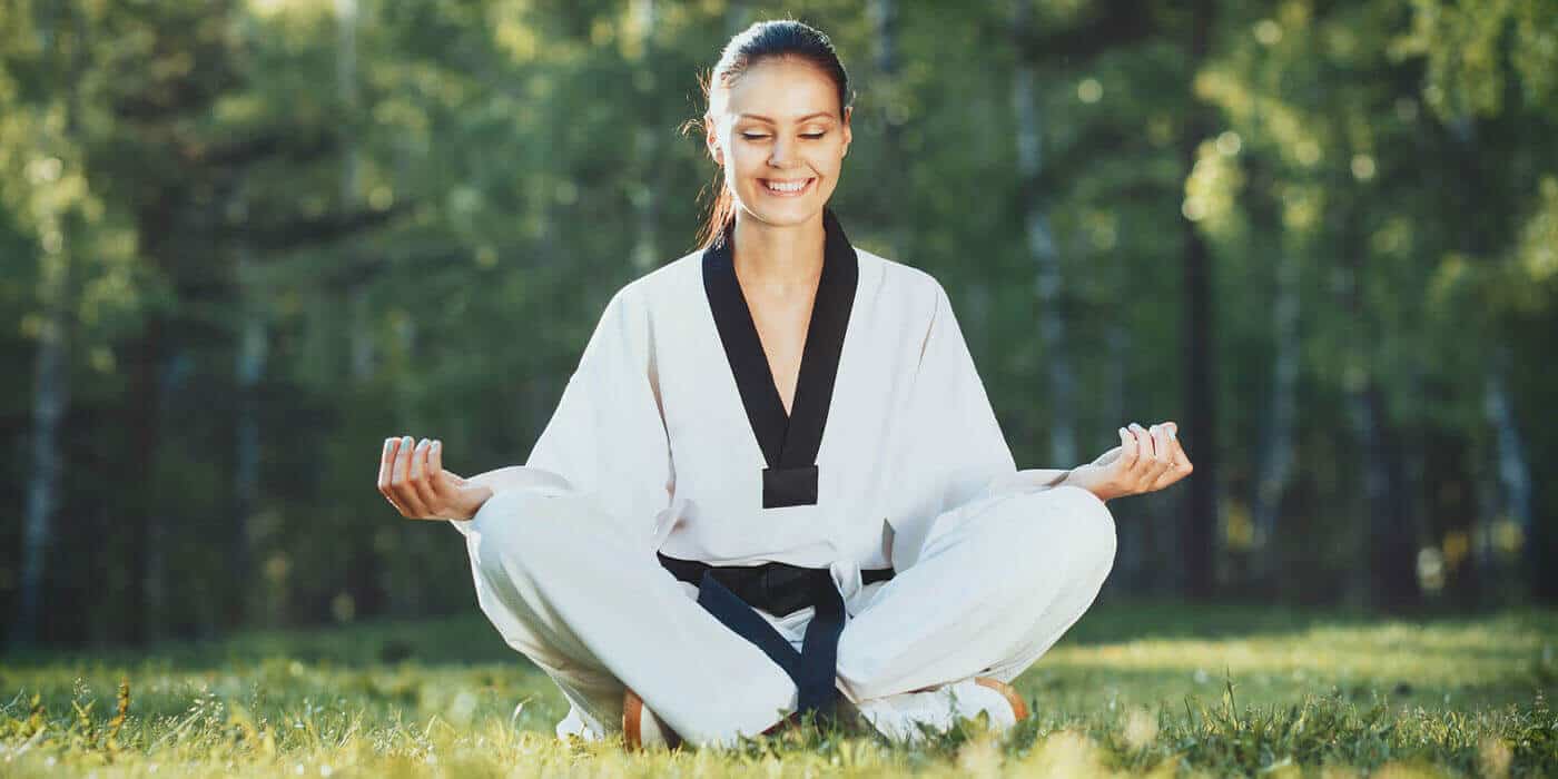 Martial Arts Lessons for Adults in Angleton TX - Happy Woman Meditated Sitting Background